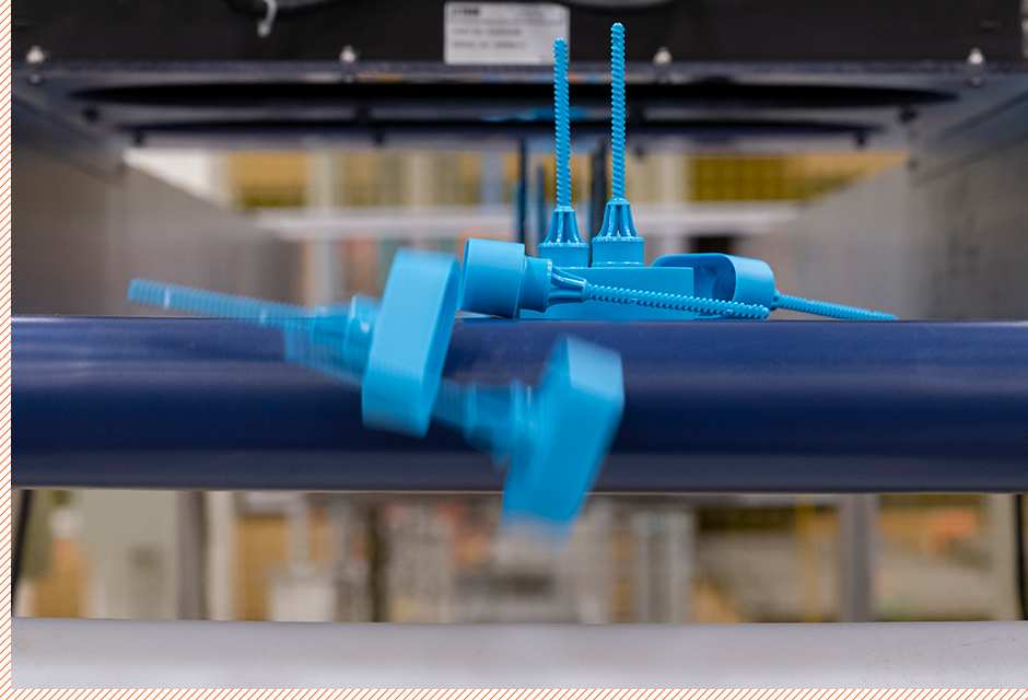 Blue plastic parts on conveyor belt